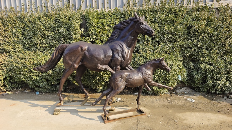 brown bronze horse and foal